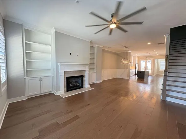 a view of an empty room with a fireplace and a window