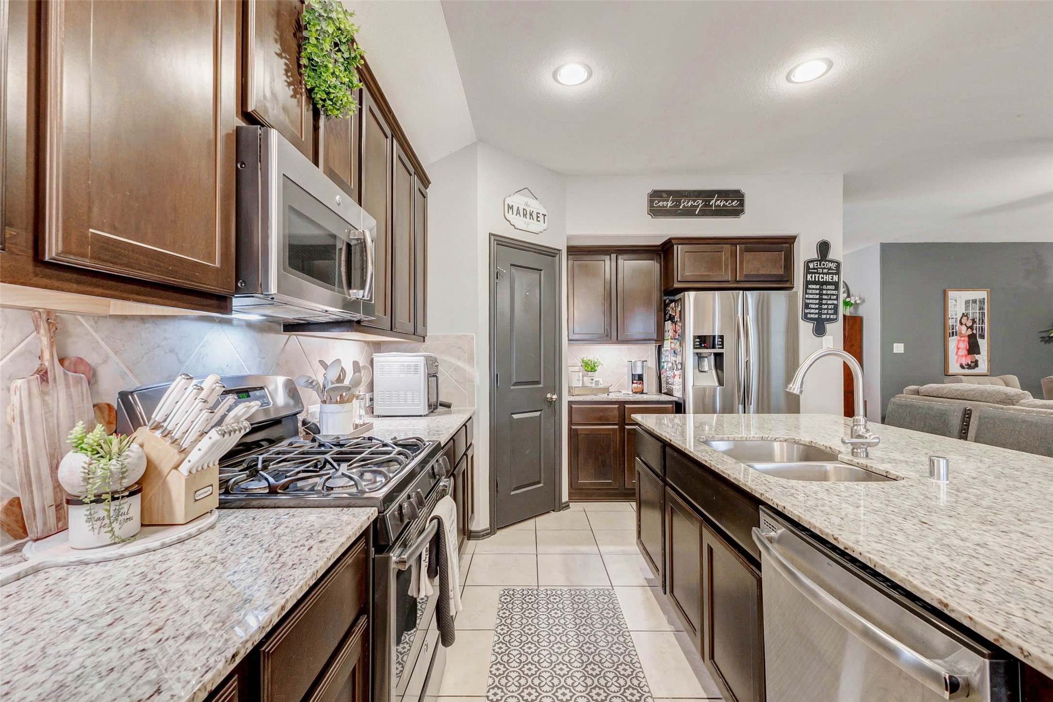 8319 Silent Deep Drive Rosenberg, TX 77469 - Photo 11 of 34 a kitchen with stainless steel appliances granite countertop a sink stove and refrigerator