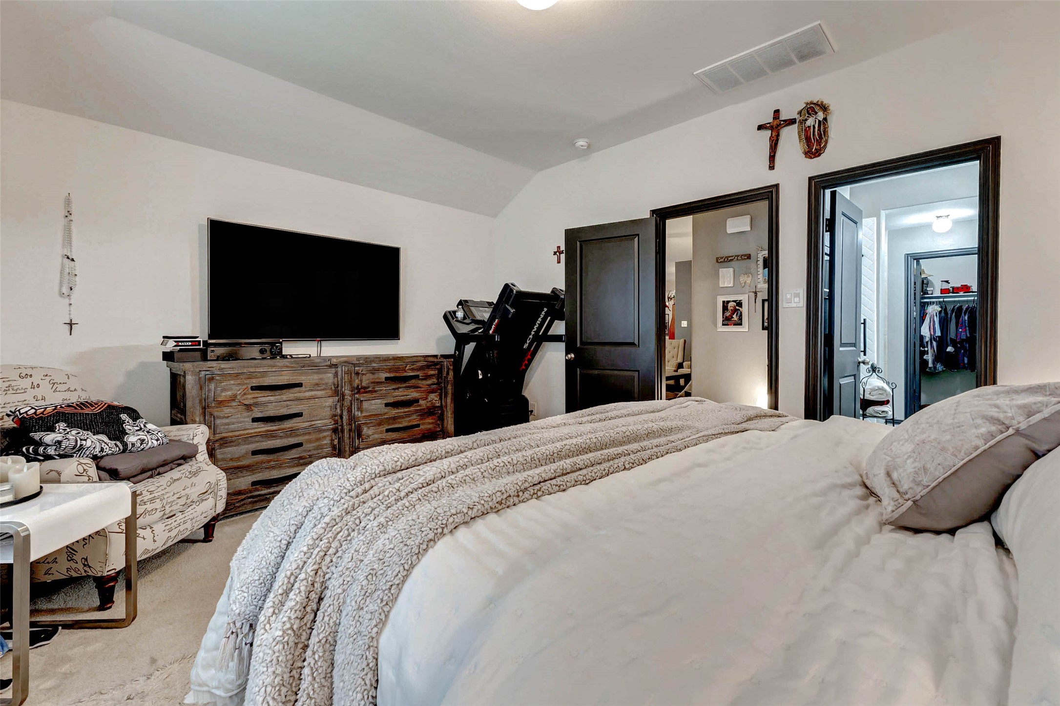 8319 Silent Deep Drive Rosenberg, TX 77469 - Photo 15 of 34 a bedroom with a bed and a flat tv screen on wall