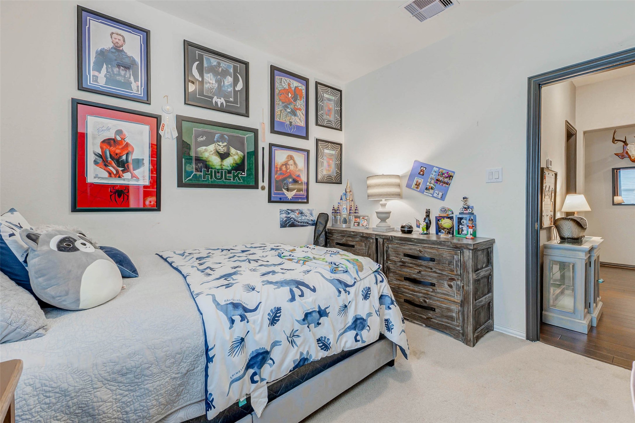 8319 Silent Deep Drive Rosenberg, TX 77469 - Photo 23 of 34 a bedroom with a bed and paintings on the wall