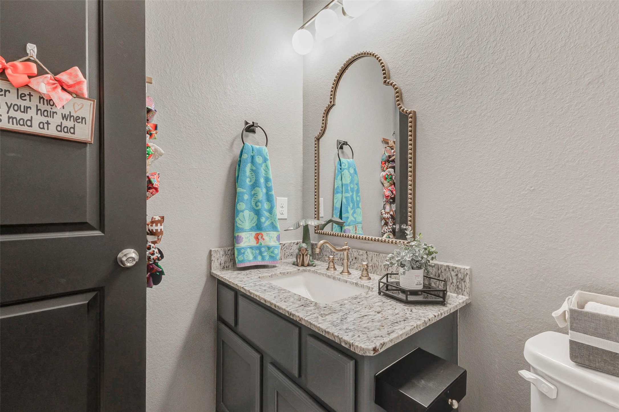 8319 Silent Deep Drive Rosenberg, TX 77469 - Photo 24 of 34 a bathroom with a granite countertop sink a toilet and a mirror