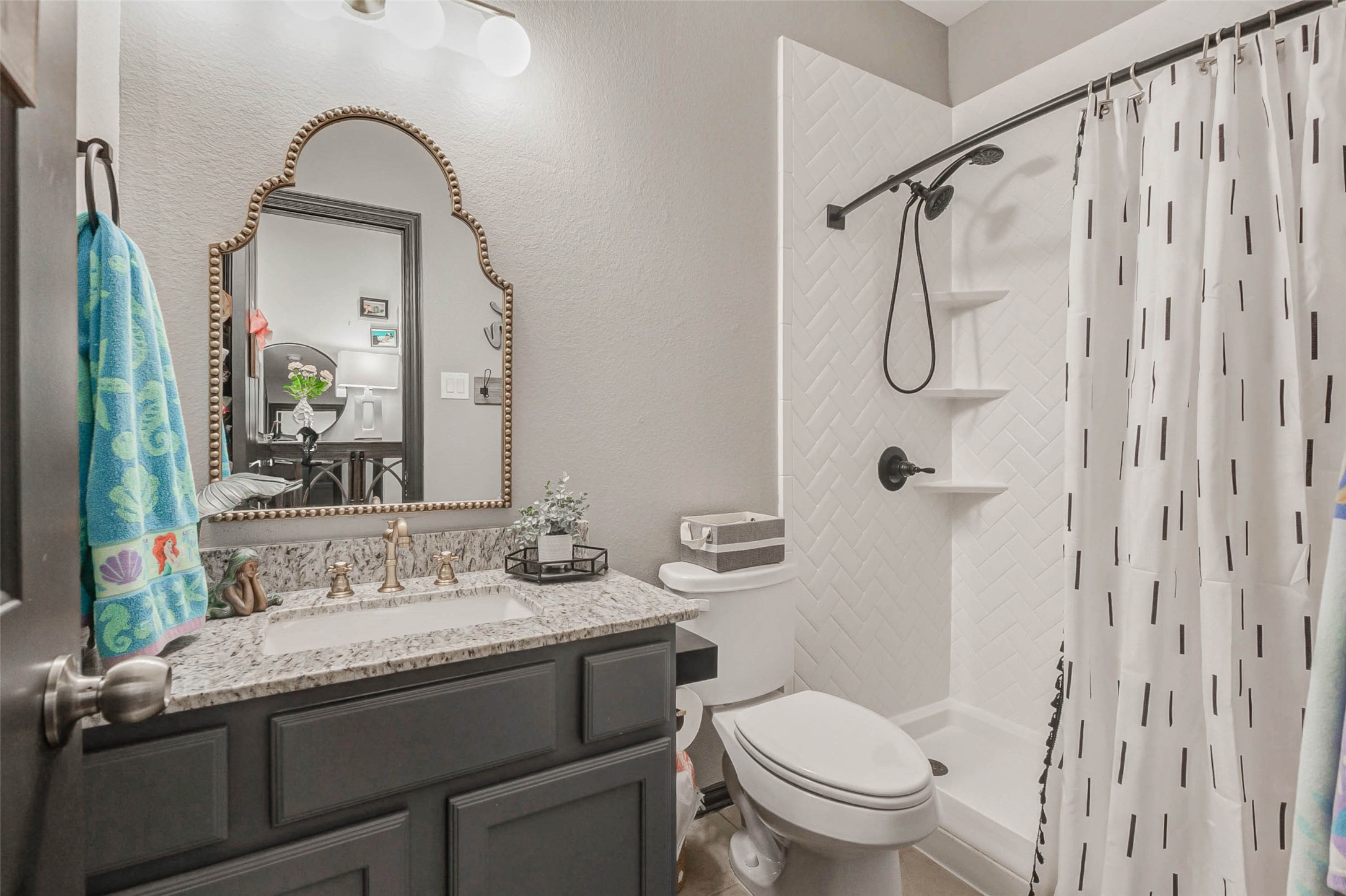 8319 Silent Deep Drive Rosenberg, TX 77469 - Photo 25 of 34 a bathroom with a granite countertop sink toilet and shower
