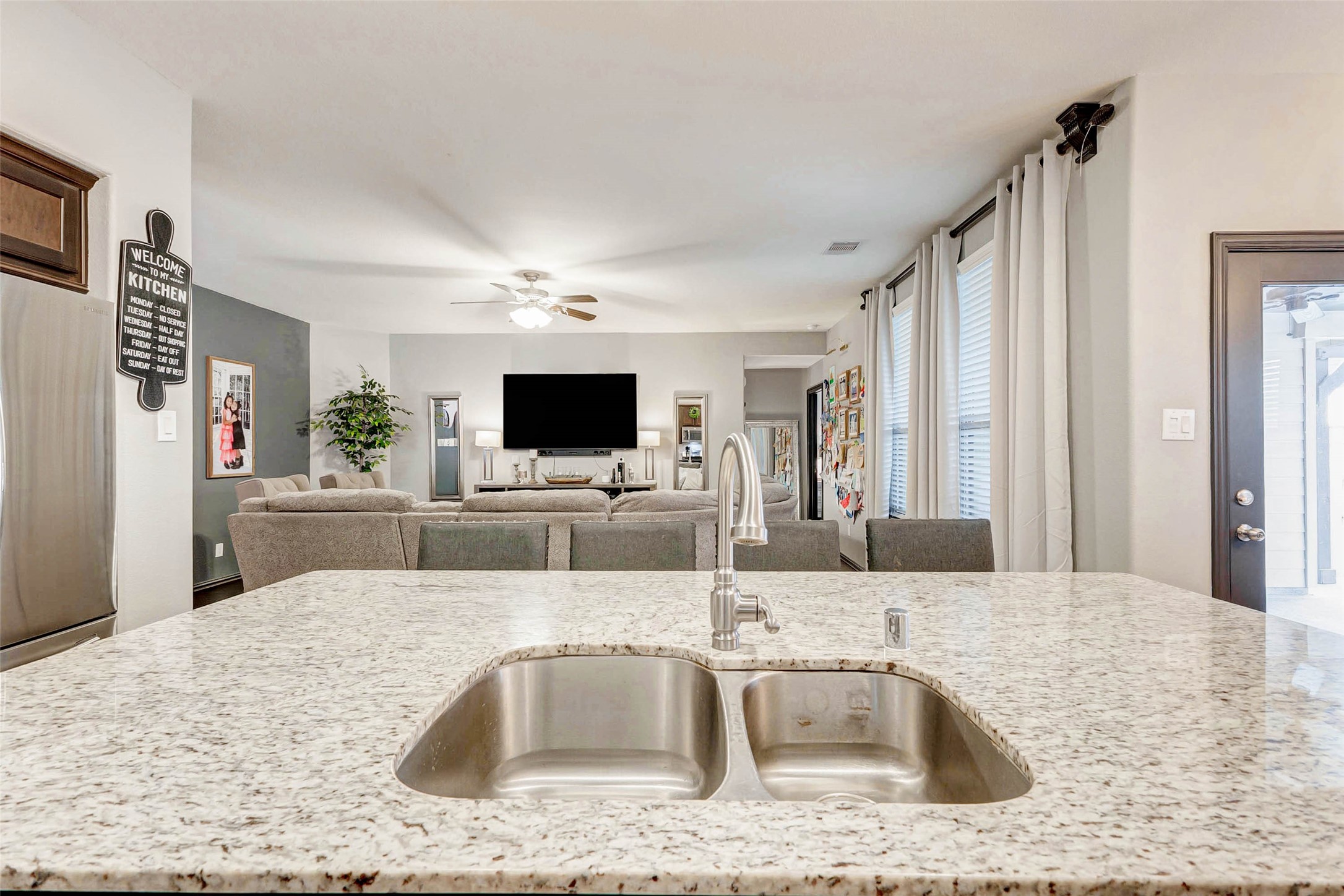 8319 Silent Deep Drive Rosenberg, TX 77469 - Photo 7 of 34 a kitchen with stainless steel appliances kitchen island granite countertop a sink and a refrigerator