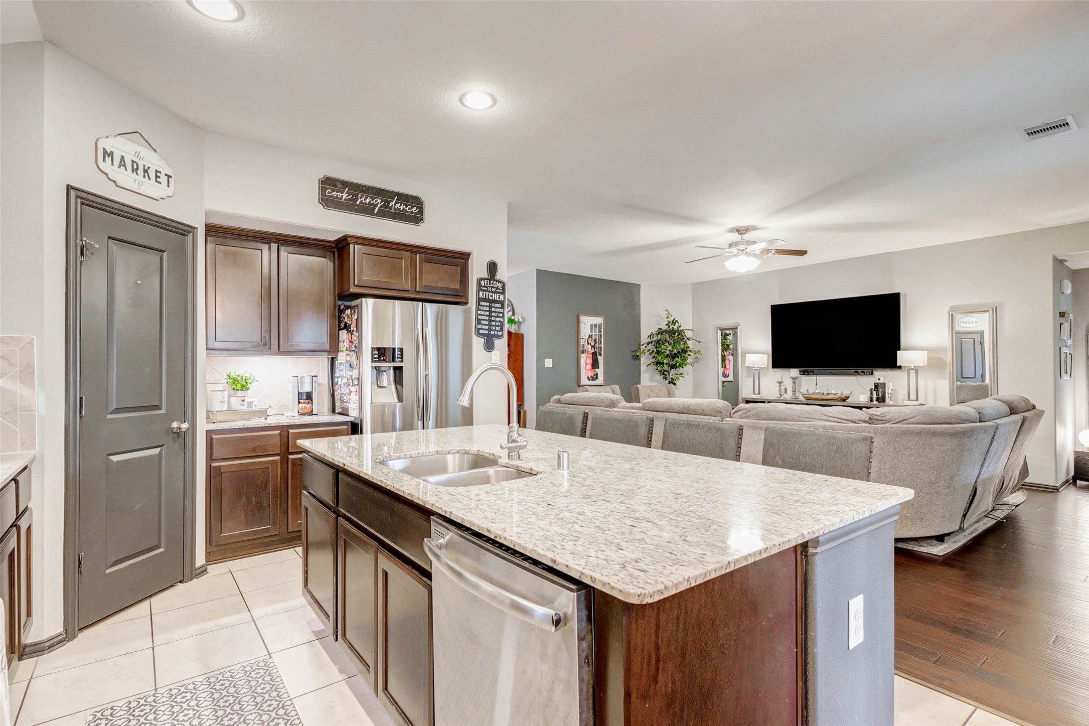 8319 Silent Deep Drive Rosenberg, TX 77469 - Photo 8 of 34 a living room with stainless steel appliances kitchen island granite countertop a sink and cabinets