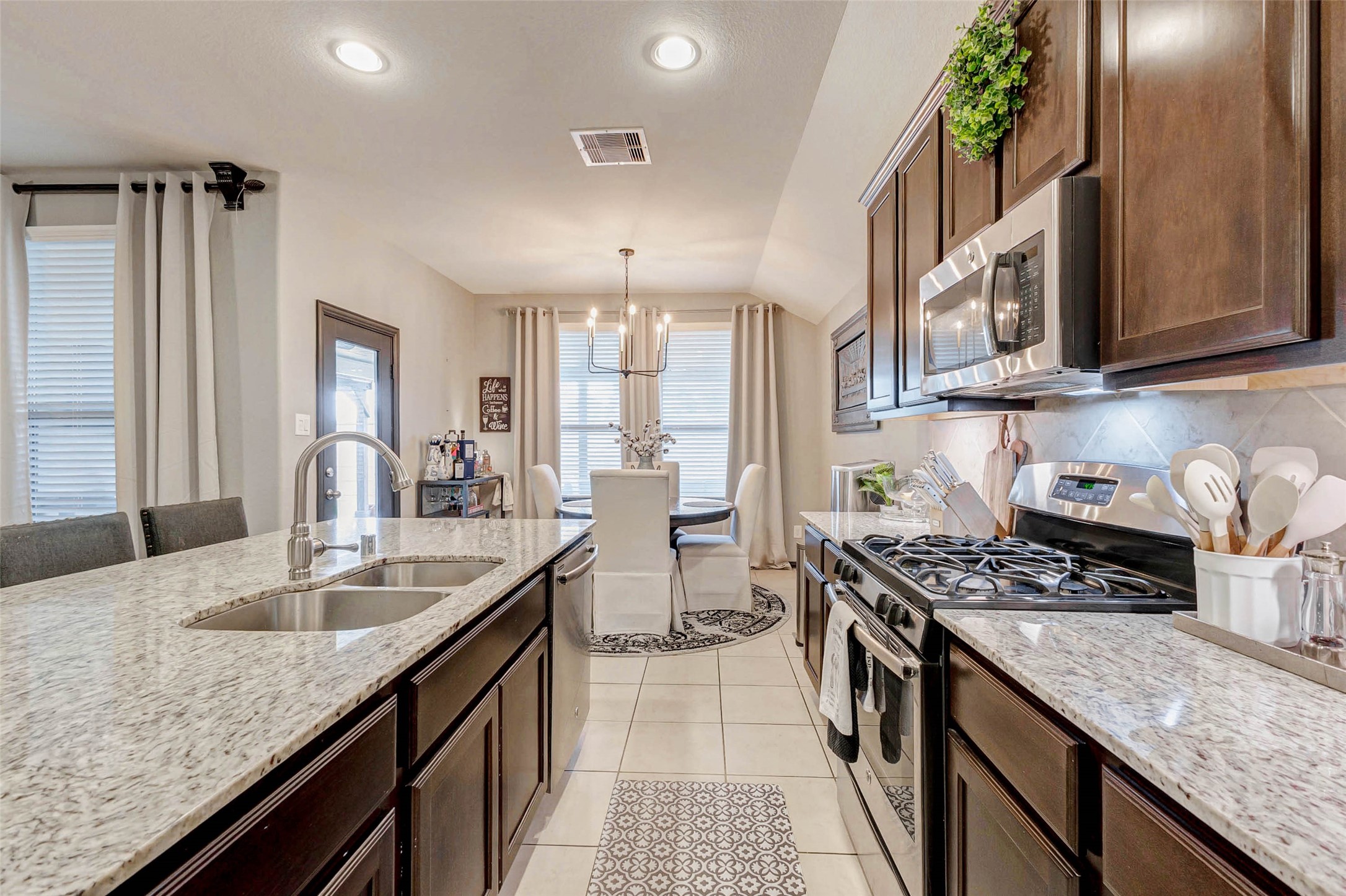 8319 Silent Deep Drive Rosenberg, TX 77469 - Photo 10 of 34 a kitchen with stainless steel appliances granite countertop a sink stove and cabinets