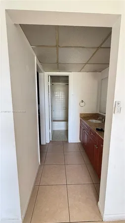 a kitchen with a refrigerator and cabinets