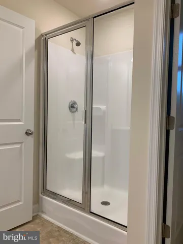 a bathroom with a glass shower door