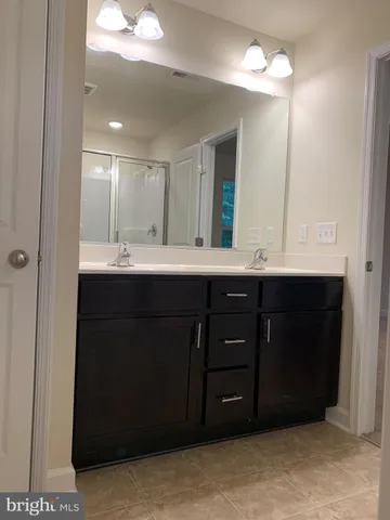 a bathroom with a sink vanity and a mirror