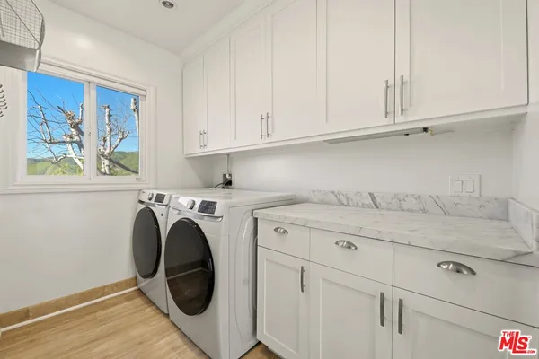 a utility room with sink dryer and washer