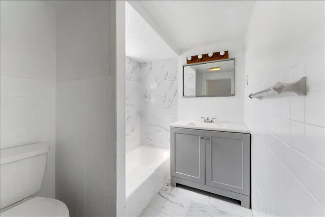 a bathroom with a sink a toilet and mirror