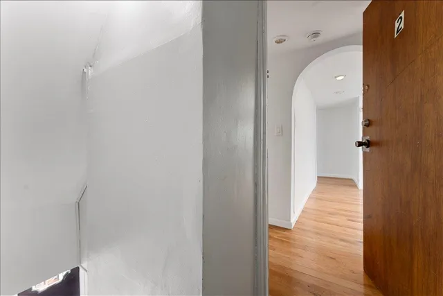 a view of a hallway with wooden floor