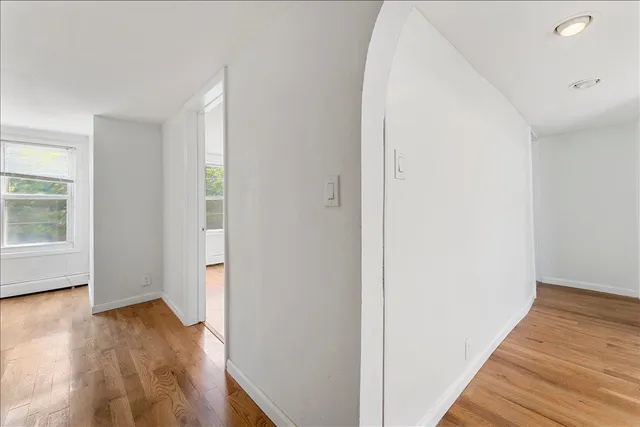 a view of a hallway with wooden floor