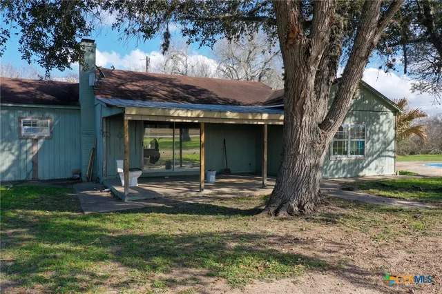 a view of a chair and grass