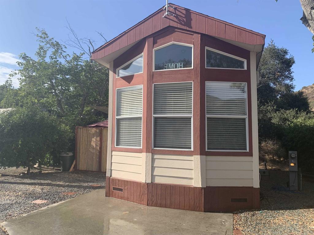 14615 Otay Lakes Road, Unit L7 Dulzura, CA 91917 - Photo 1 of 1 a front view of a house with a yard
