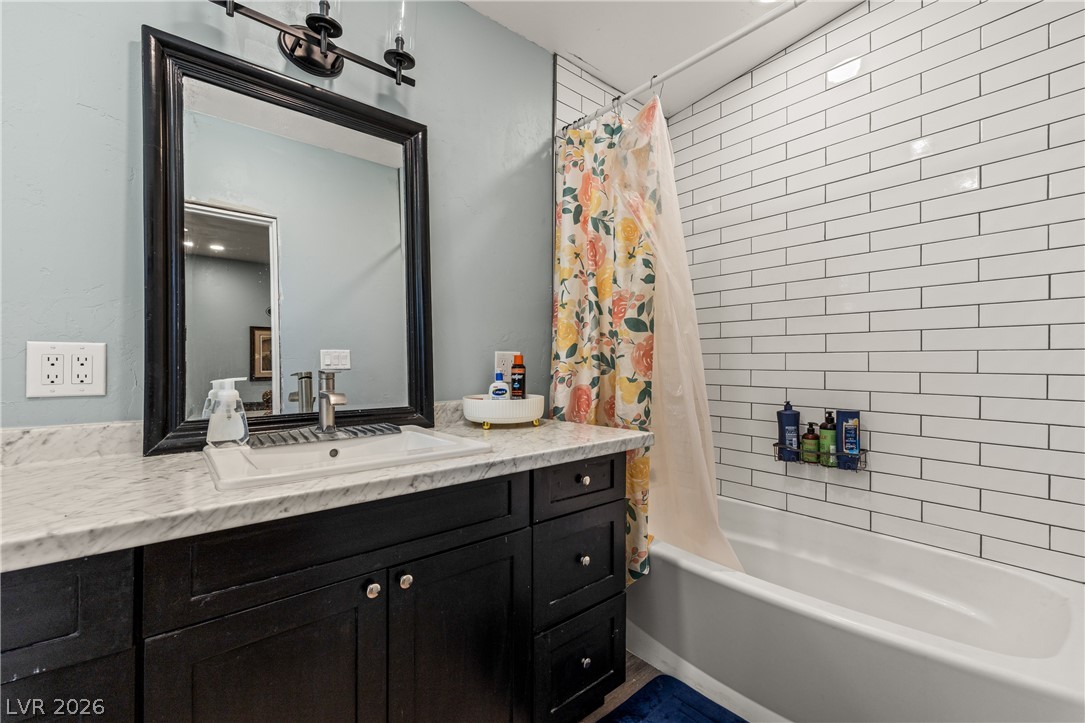 750 Leming Avenue Overton, NV 89040 - Photo 54 of 82 This bathroom features a contemporary vanity and a classic tiled shower-tub combination.