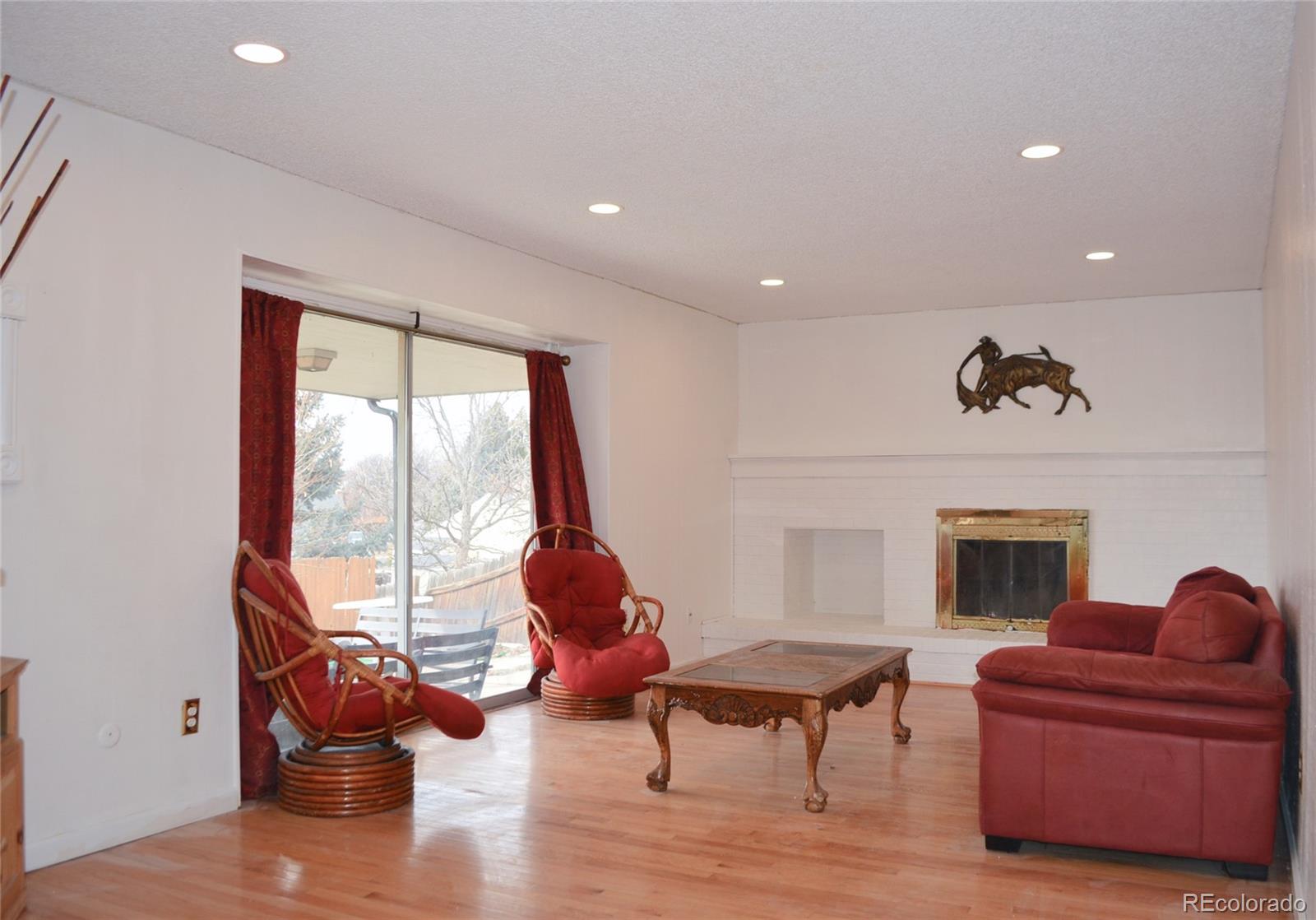 2087 South Quintero Street Aurora, CO 80013 - Photo 11 of 34 a living room with furniture a fireplace and a floor to ceiling window