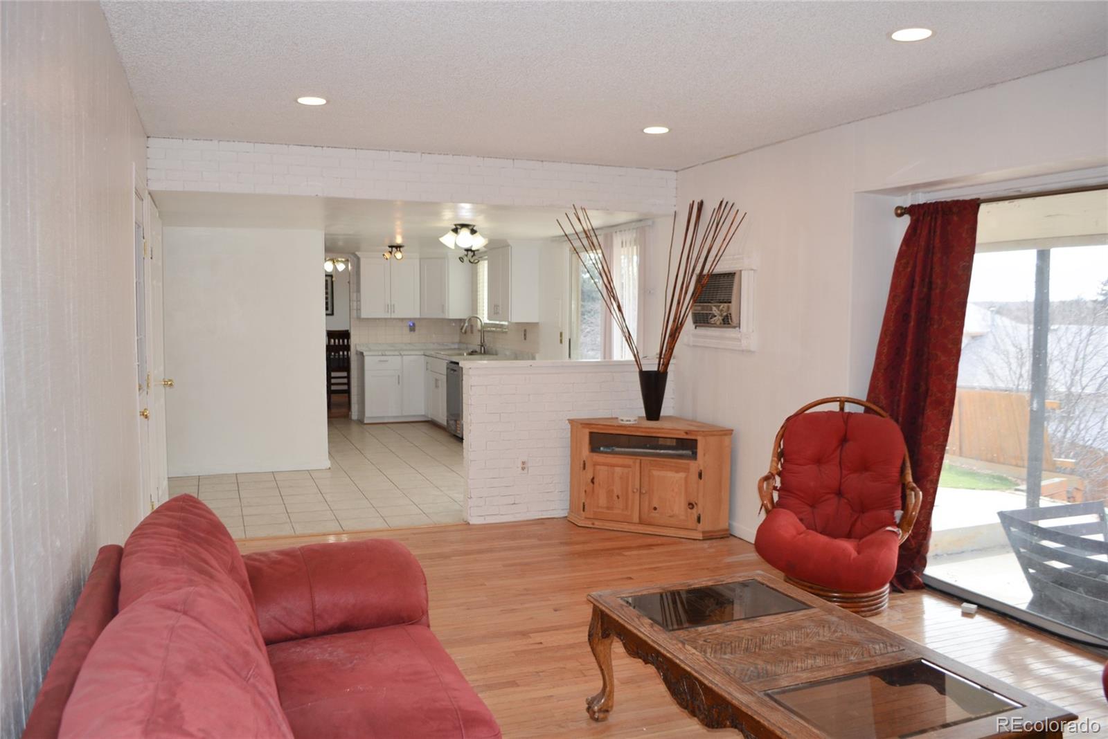 2087 South Quintero Street Aurora, CO 80013 - Photo 12 of 34 a living room with furniture and a large window