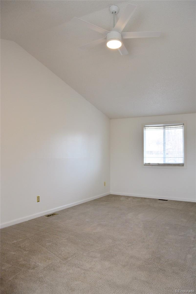 2087 South Quintero Street Aurora, CO 80013 - Photo 14 of 34 an empty room with a window and ceiling fan