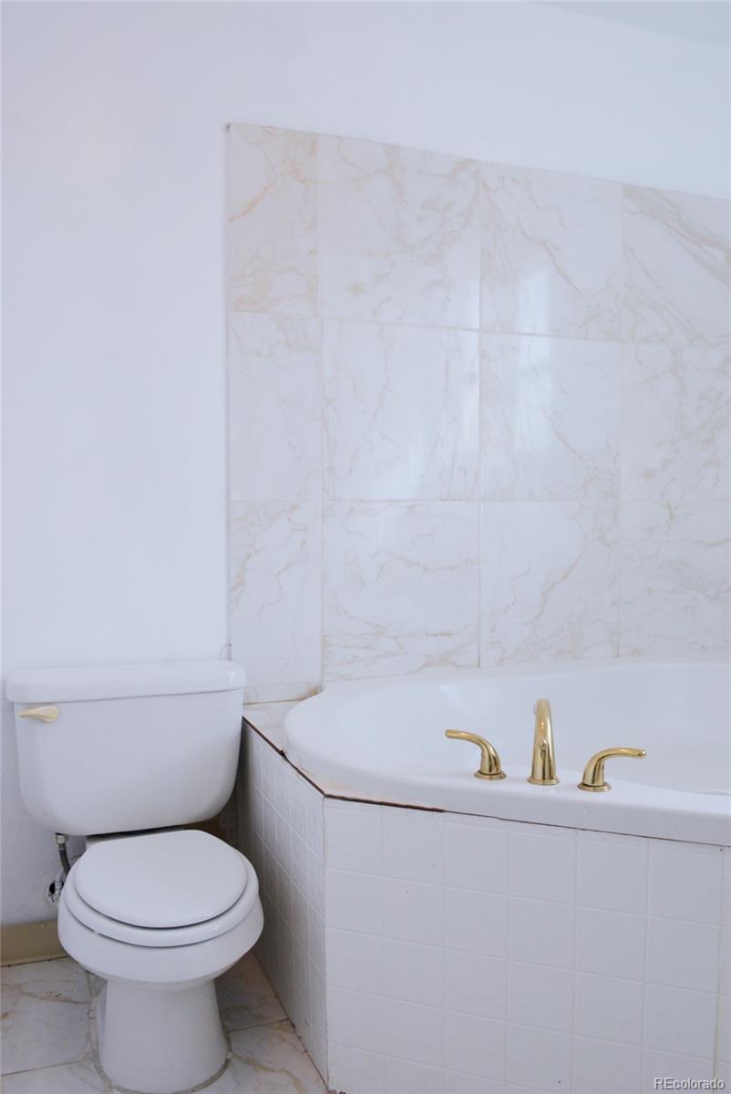 2087 South Quintero Street Aurora, CO 80013 - Photo 18 of 34 a white toilet sitting next to a white sink