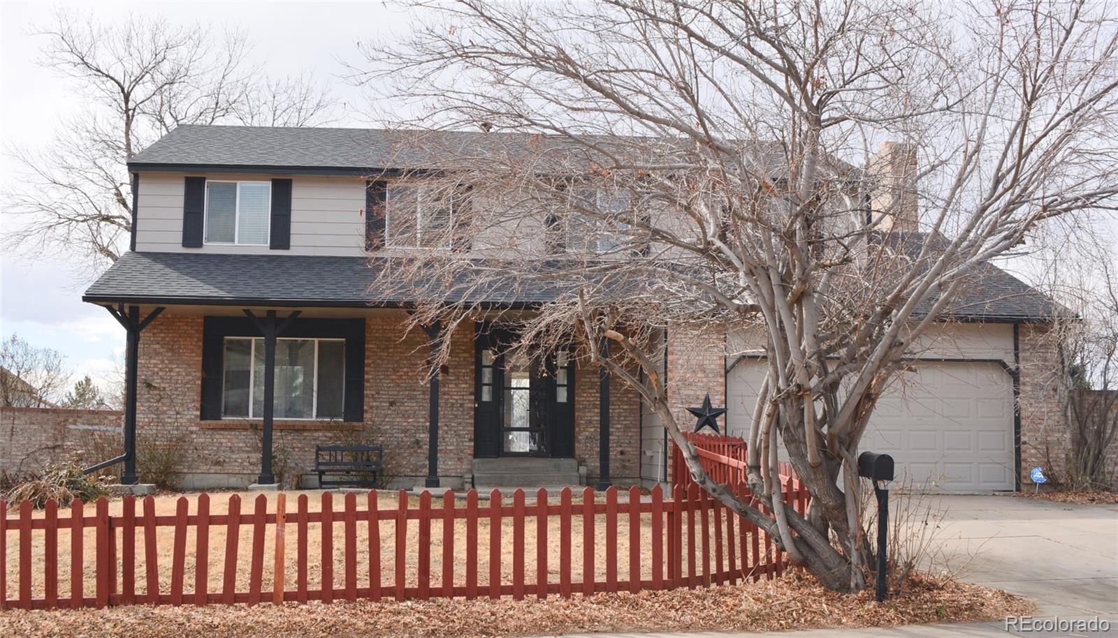 2087 South Quintero Street Aurora, CO 80013 - Photo 2 of 34 a front view of a house with a tree