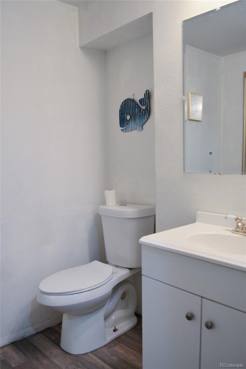 2087 South Quintero Street Aurora, CO 80013 - Photo 30 of 34 a white toilet sitting next to a bathroom sink