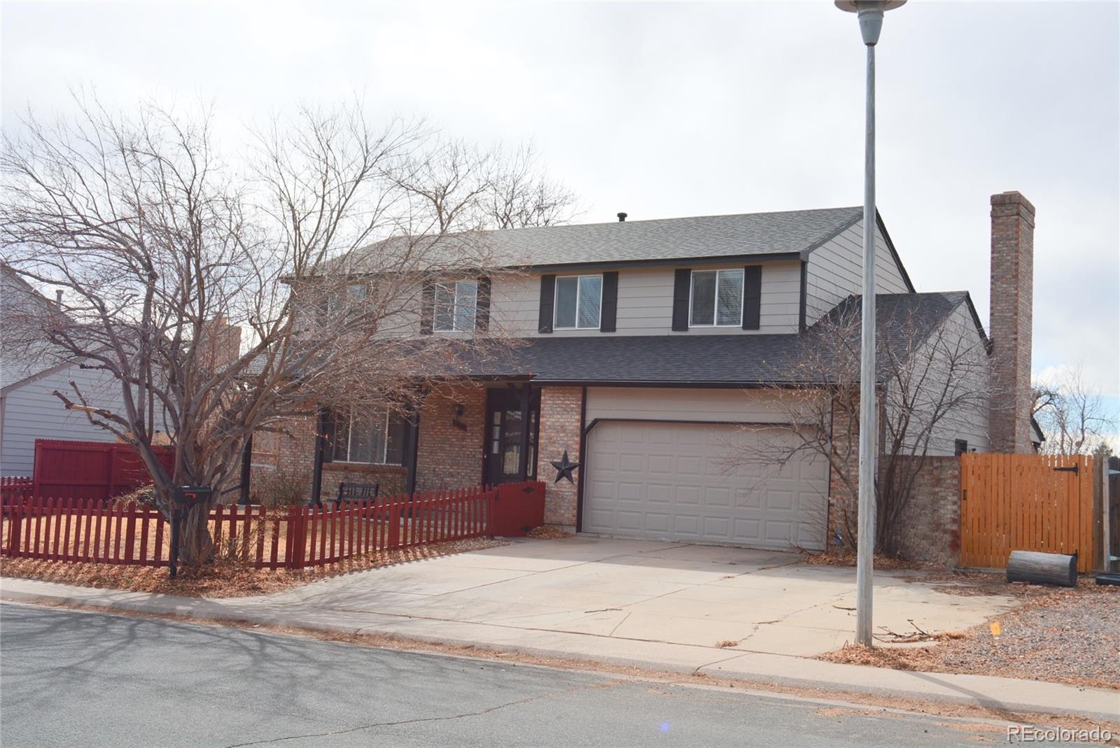 2087 South Quintero Street Aurora, CO 80013 - Photo 3 of 34 a front view of a house with a garage