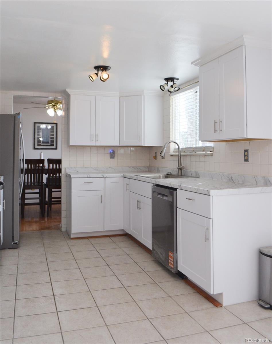 2087 South Quintero Street Aurora, CO 80013 - Photo 6 of 34 a kitchen with a stove sink and cabinets