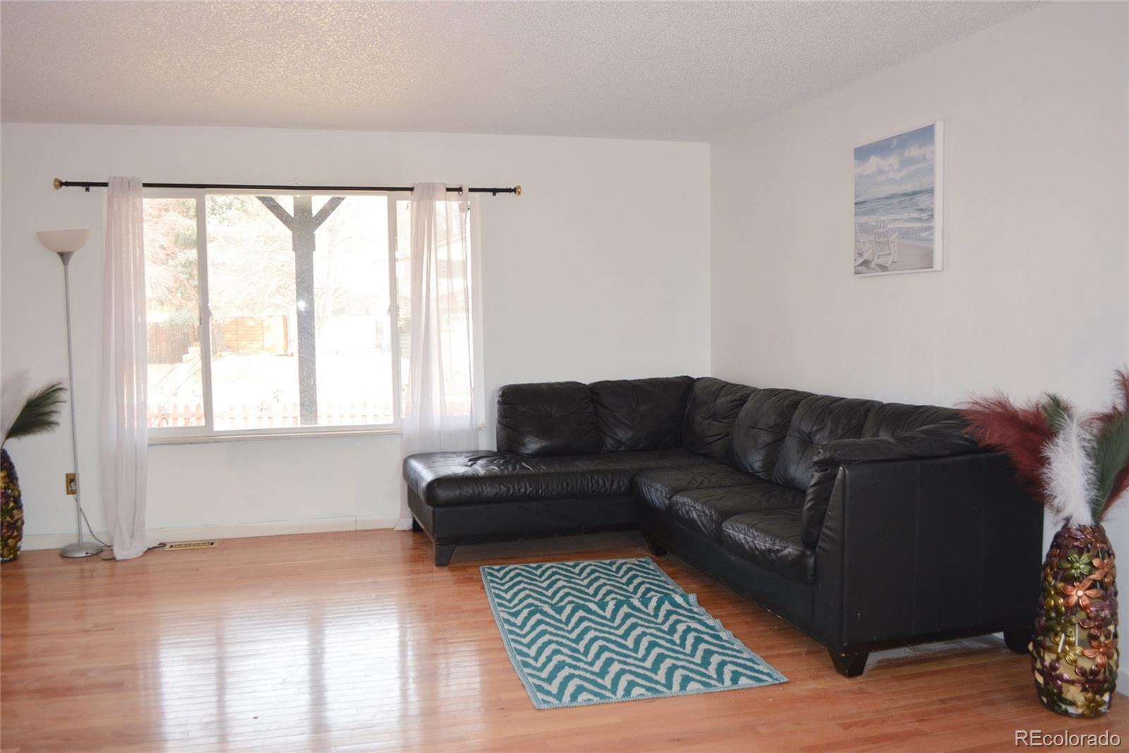2087 South Quintero Street Aurora, CO 80013 - Photo 8 of 34 a living room with furniture and a window