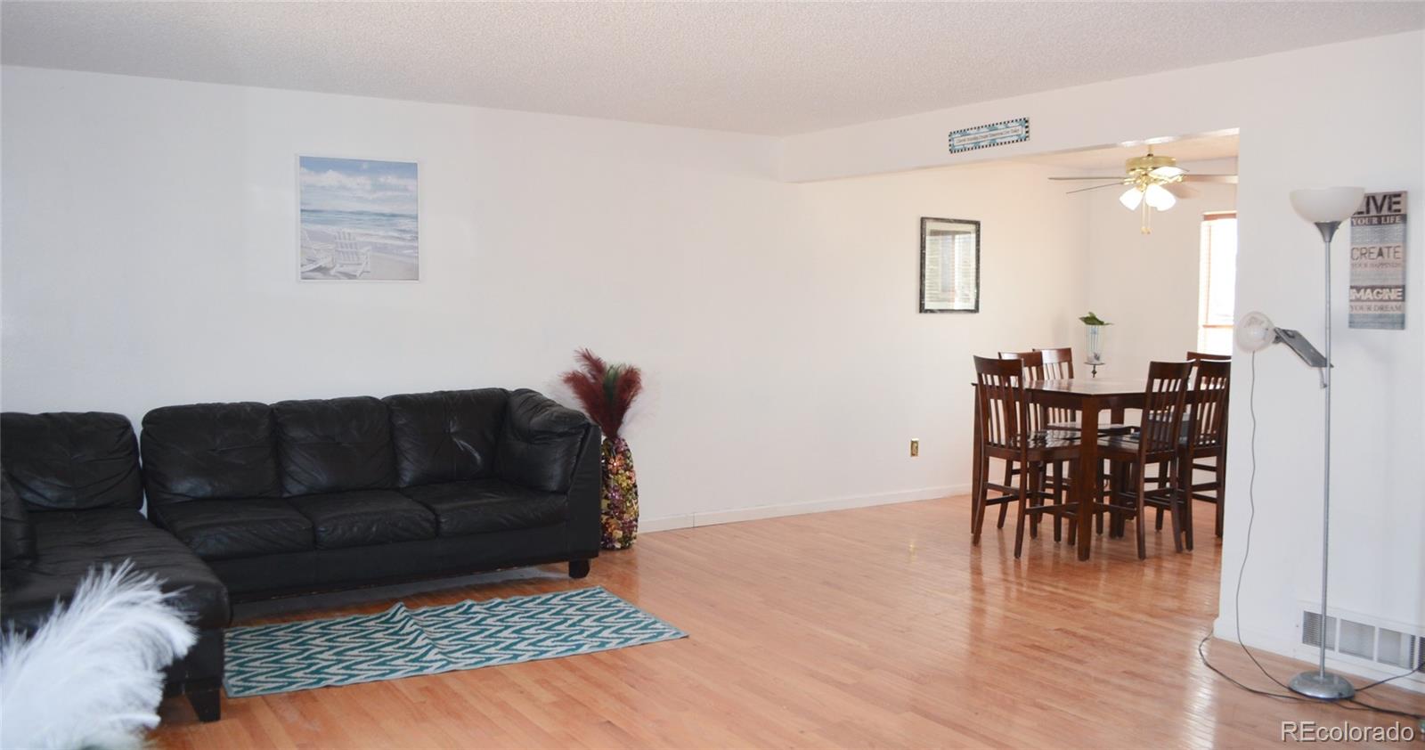 2087 South Quintero Street Aurora, CO 80013 - Photo 9 of 34 a living room with furniture and wooden floor