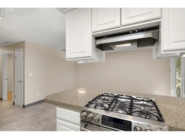 a kitchen with wooden cabinets and a stove top oven