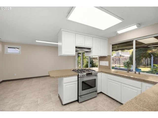 a kitchen that has a sink and a stove