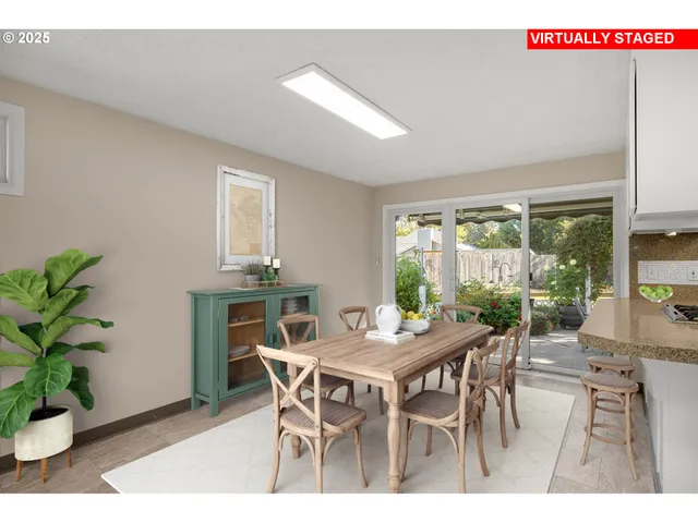 a dining room with furniture potted plants and wooden floor