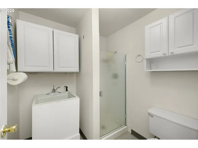 a utility room with cabinets washer and dryer
