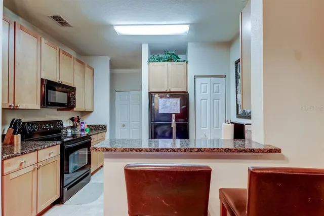 a kitchen with stainless steel appliances a stove sink microwave and cabinets