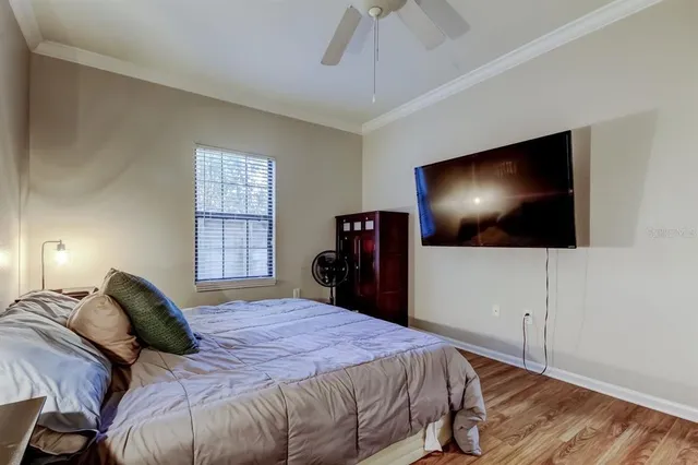a bedroom with a bed and a flat screen tv