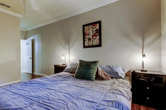 a bedroom with a bed and lamp