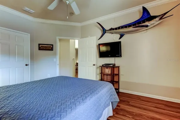a bedroom with a bed and a flat screen tv