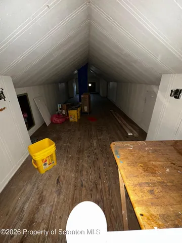 a bathroom with a toilet a sink a window and mirror