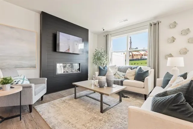 a dining room with furniture a large window and stainless steel appliances