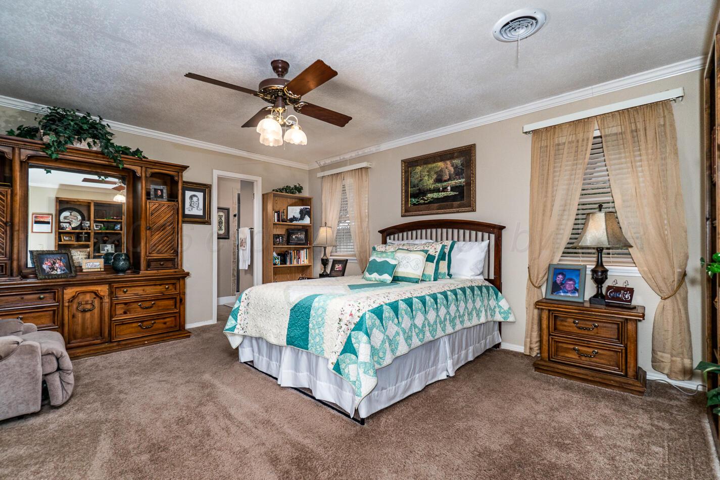 6405 Ridgewood Drive Amarillo, TX 79109 - Photo 13 of 25 a bedroom with a bed dresser and a window