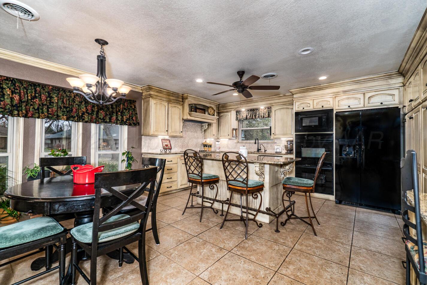 6405 Ridgewood Drive Amarillo, TX 79109 - Photo 9 of 25 a view of a dining room with furniture and chandelier