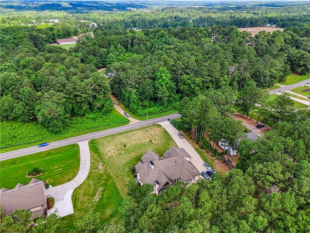852 Tom Miller Road Bethlehem, GA 30620 - Photo 68 of 68 an aerial view of a house with a yard and lake view