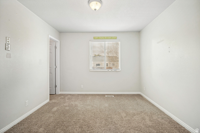 5529 Ridge Hollow Way Kearns, UT 84118 - Photo 16 of 23 Carpeted interior space with a single window featuring horizontal blinds