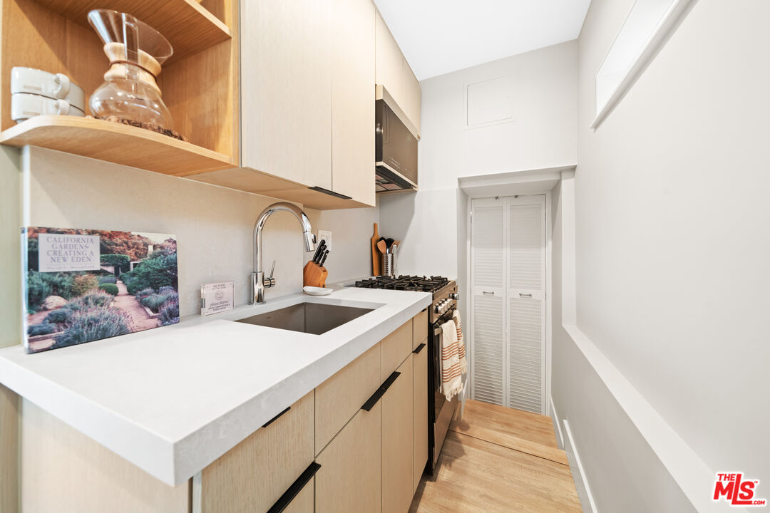 7520 Earldom Avenue Playa del Rey, CA 90293 - Photo 23 of 28 a kitchen with a sink and a refrigerator