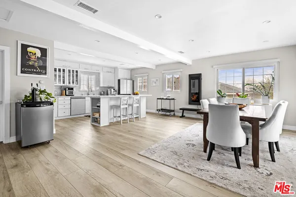 a living room with furniture and a dining table with kitchen view