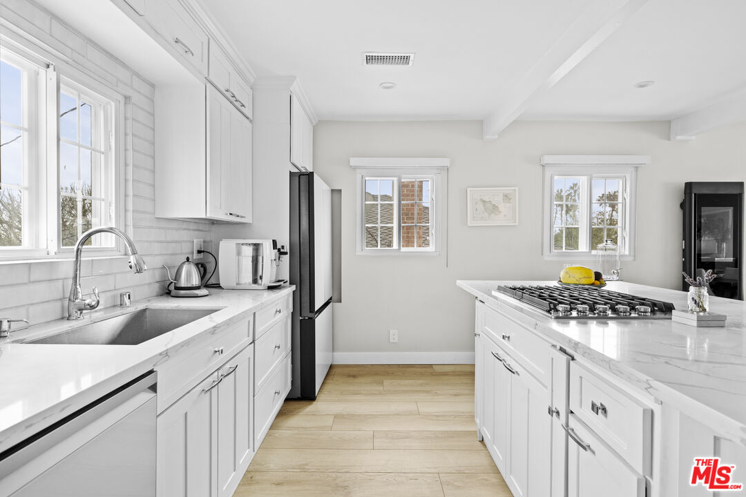 7520 Earldom Avenue Playa del Rey, CA 90293 - Photo 5 of 28 a kitchen with stainless steel appliances granite countertop a sink stove and refrigerator