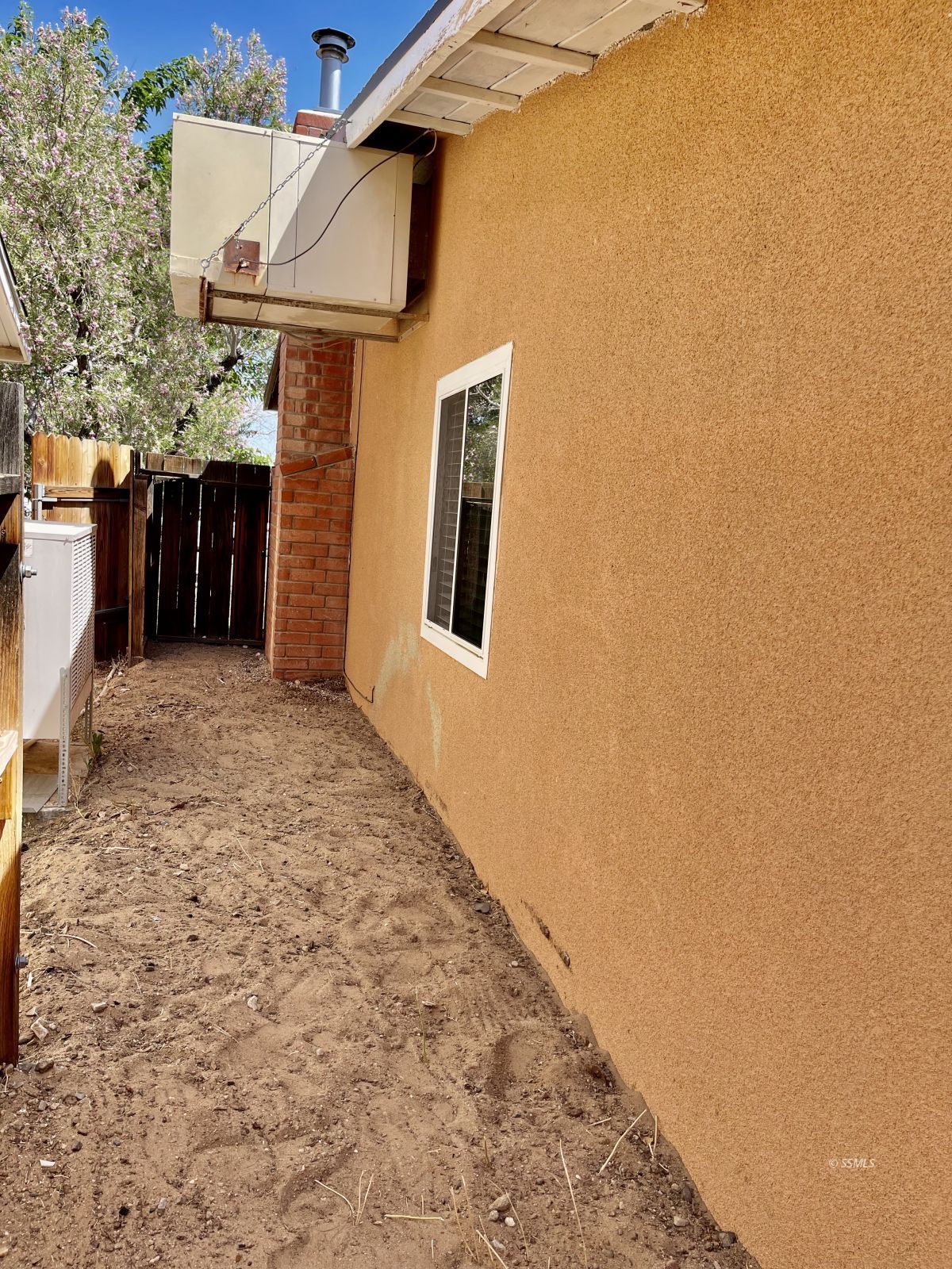 233 West St George Avenue Ridgecrest, CA 93555 - Photo 38 of 47 a view of a brick house with a wooden wall