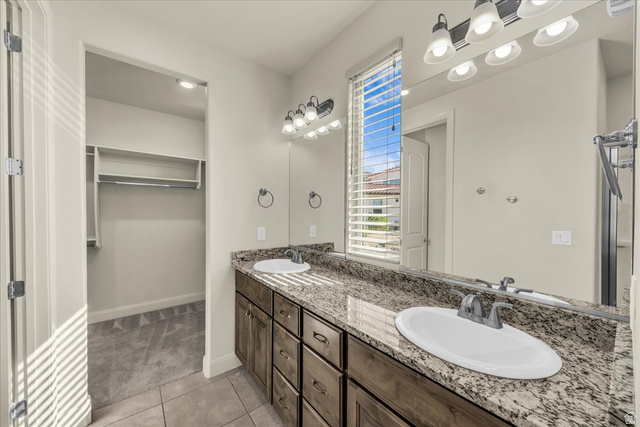 794 North Via Modelo Circle Washington, UT 84780 - Photo 20 of 21 Full bath with double vanity, light tile patterned floors, and a walk in closet