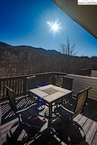 a view of a roof deck with chair and wooden floor