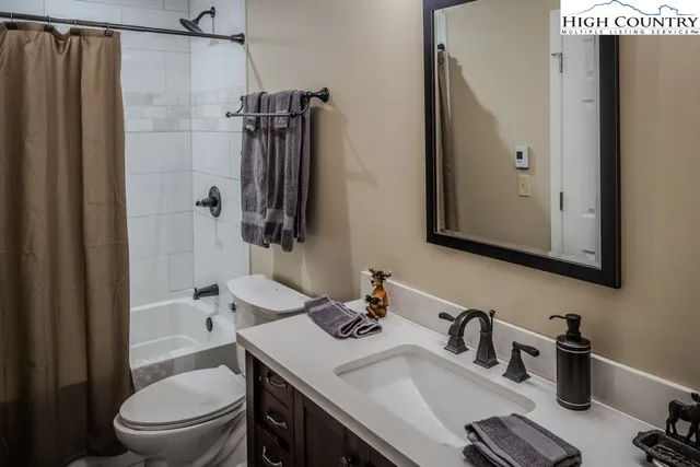 a bathroom with a sink toilet a tub and shower